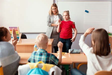 Young teacher and student in the classroom during the first maths lessonの写真素材