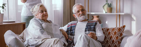 Elderly couple sitting on the sofa in the nursing homeの写真素材