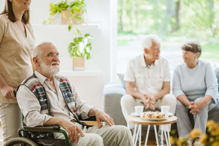 Senior people during afternoon in the nursing home living room