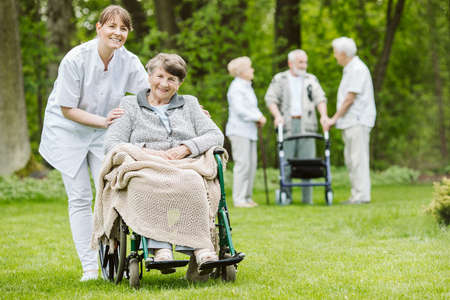 Happy senior woman and helpful caregiver, nursing home concept photosの写真素材