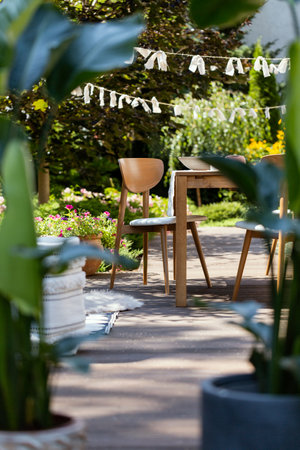 Wooden chair and the table set in the garden patioの写真素材