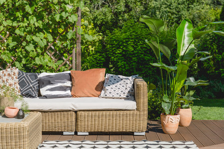 Rattan sofa and coffee table on wooden porchの写真素材