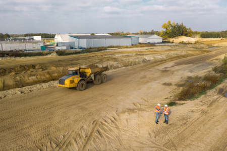 Two workers preparing the construction site for the excavatorの写真素材