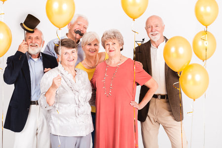 Group of happy senior people celebrating and having fun togetherの写真素材