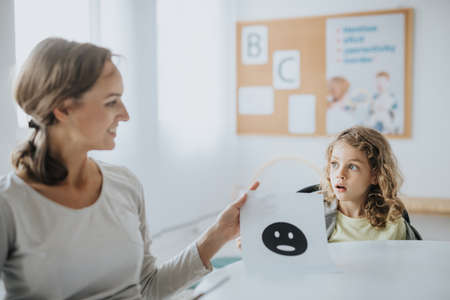 Female pedagogue practicing with little boy expressing the emotionsの写真素材