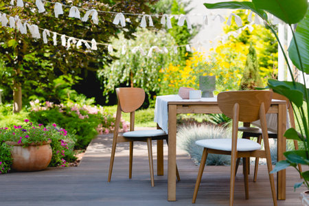 Wooden table and chairs in the summer gardenの写真素材