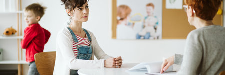 ADHD child's therapist talk with mother and ask questions during first sessionの写真素材