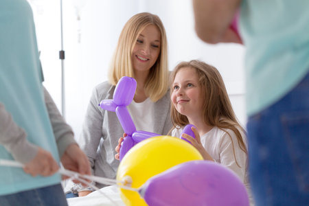 Little girl in a hospital and her mom having fun togetherの写真素材