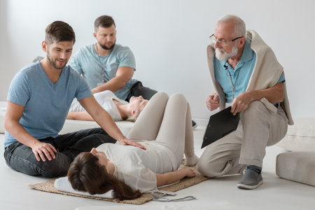 Young man healing the patient from the pain using bioenergy