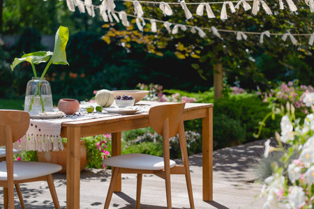 Table and chairs set in the garden on wooden deckの写真素材