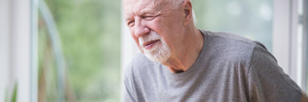 Senior gray man home alone having a heart attackの写真素材