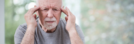 Older man holding his head because of migraine, copy space on the photoの写真素材