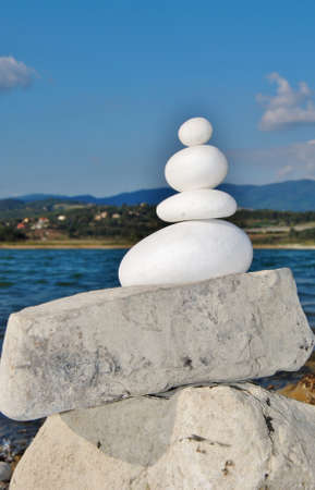 round white stones stacked in the background lakeの写真素材
