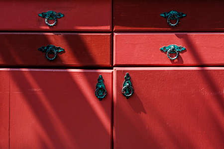 Vintage red drawer with old paintの写真素材