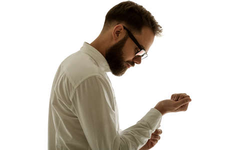 Side view portrait of confident bearded man in white shirt