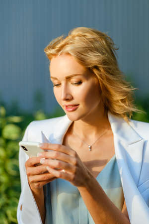 Closeup shot of pretty business lady with a smartphoneの写真素材