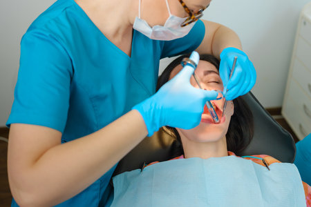 Female dentist with cartridge syringe injecting anesthetic medicine before teeth treatmentの写真素材