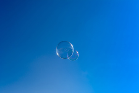 Soap bubbles, Blowing soap bubble on Blue sky backgroundの写真素材