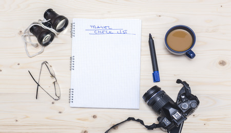 Travel check list copy space wood background, cup of coffee, photo camera, binocular
の写真素材