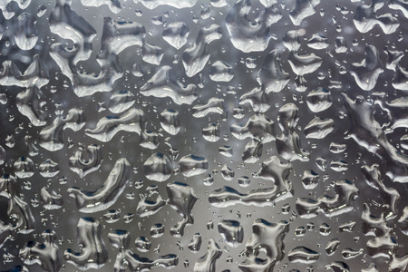 Texture of glass with frozen drops of water on a winter dayの写真素材