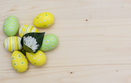 Easter eggs and snowdrops on wooden boardの写真素材