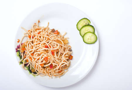 spagetti with vegetables on the white plate isolated on whiteの写真素材