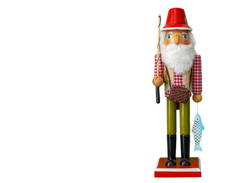 fisherman nutcracker doll in red plaid shirt, red hat and vest holding a fishing rod and fishの写真素材
