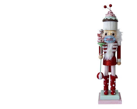 candy themed nutcracker doll in red suit and cupcake hat wearing a 2020 face maskの写真素材