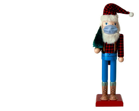 lumber jack nutcracker doll with face mask wearing a red plaid shirt and carrying a pine treeの写真素材