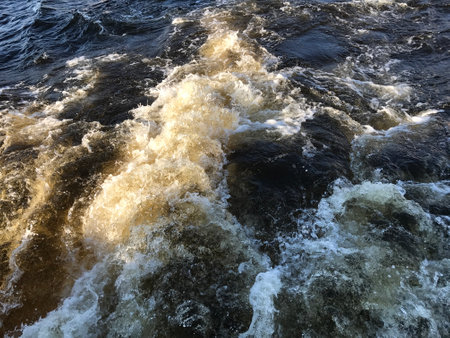 Water waves on the surface of the river, closeup of photo