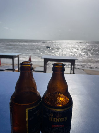 Bottles of beer on a table at the beach. Selective focus.の写真素材