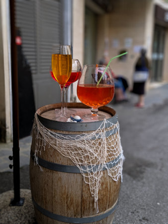 Glasses of wine on wine barrel.の写真素材