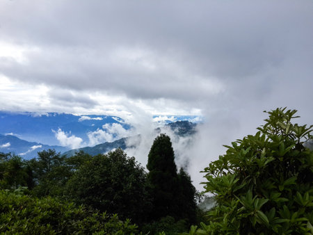 Mountains covered with trees ,clouds and blue sky.の写真素材