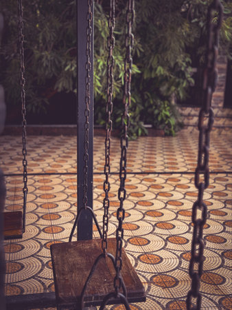 A photo a wooden swing in a resort.の写真素材