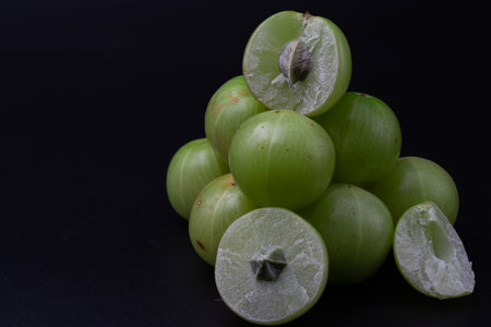 Close up shot of whole Amla also known as Indian gooseberry and sliced amla .