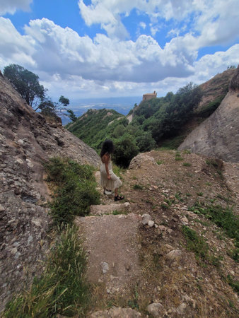 A lady standing in the mountains and enjoying the mountain view .の写真素材