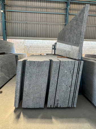 Close up shot of vertically stacked granite slabs in a factory.の写真素材