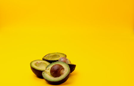 Close up of sliced Avocados placed on a yellow background