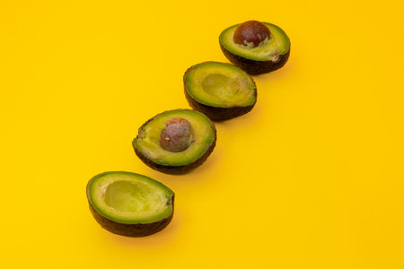 Close up of sliced Avocados placed on a yellow background
