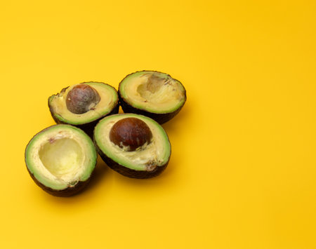 Close up of sliced Avocados placed on a yellow background