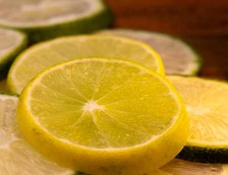 Close up shot of slices of lemon on wooden board