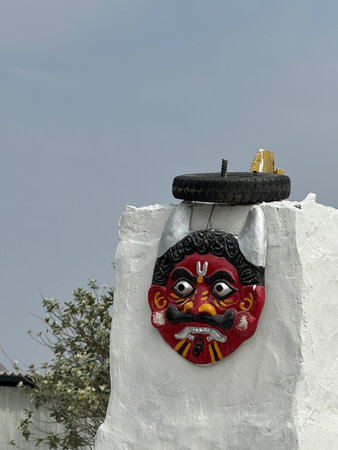 Nazar Battu or Mahakal face mask hung above the entrance to protect against evil eye