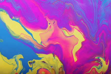 Colorful marble background.Mixed nail polishes-yellow.pink,blue and purple.