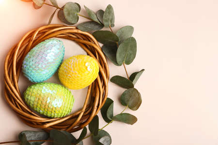 Colorful glossy easter eggs in the rattan nest.の写真素材