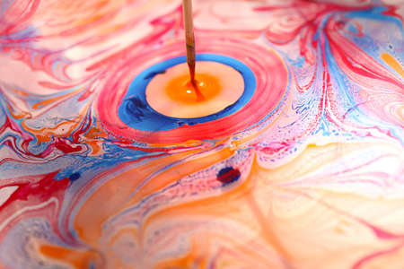 Beautiful ornament from the ink floated on water.A person draw it with wooden stroke.の写真素材