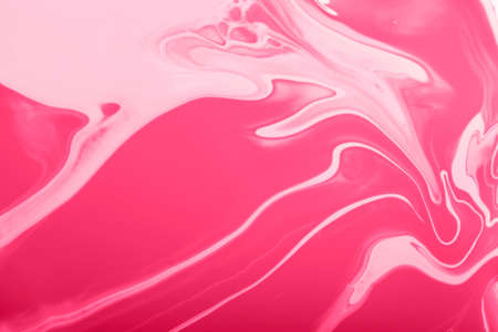 Monochrome pink marble background.Mixed nail polishes,make up concept.Beautiful stains of liquid nail laquers.Fluid art,pour painting technique.Horizontal banner,can be used as backdrop for chat.の写真素材