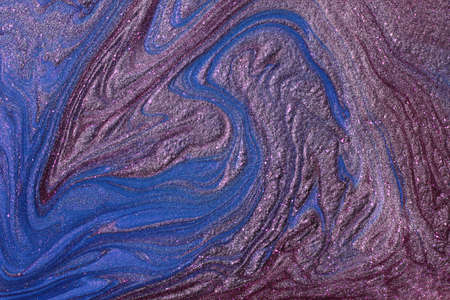 Blue and violet shimmer and glitter abstract background. Make up concept.Beautiful stains of liquid...