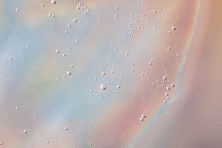 Background from cosmetic gel with bubbles on the holographuc texture.Copy space for text or design.の写真素材