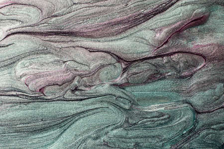 Beautiful shimmer turquoise and purple stains of liquid nail polish with stripy texture.Marbling...