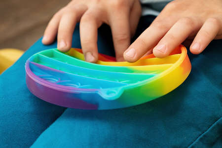 Child playing with two new silicone toy  on the playground,closeup photography.の写真素材